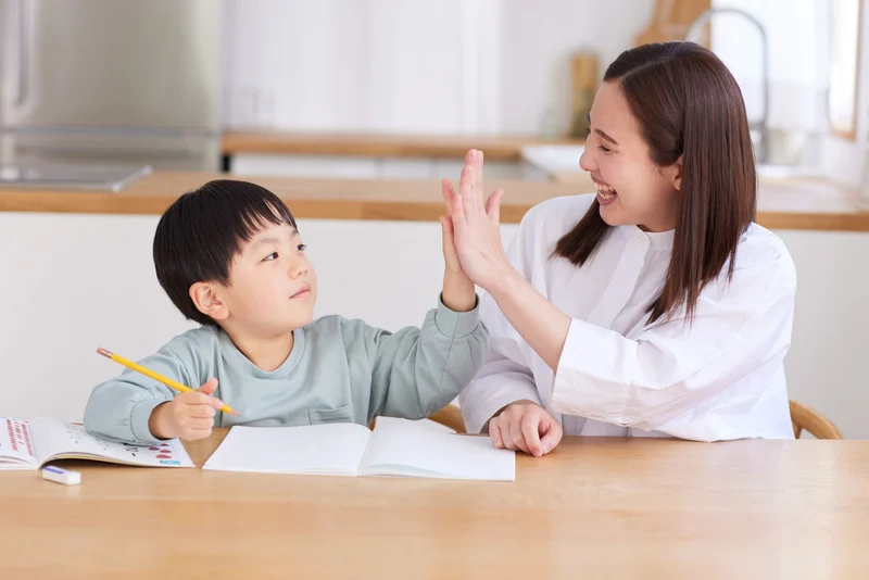 Mother high-fiving her child